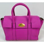 A Mulberry Purple Leather Handbag with Dust Cover. Gilded hardware. Zipped interior compartment.