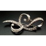 A 1940s Platinum and Diamond Scrolled Brooch. 2ct of brilliant round cut diamonds make this piece