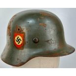 A WW2 German M35 Police Helmet Small Size 60. Maker: N.S. Vereinigte Deutsche Nickelwerke AG,