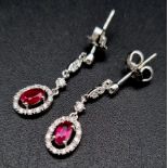 A Superb Pair of 18K White Gold Ruby and Diamond Triple Drop Earrings. 2.9g total weight. 22mm drop.