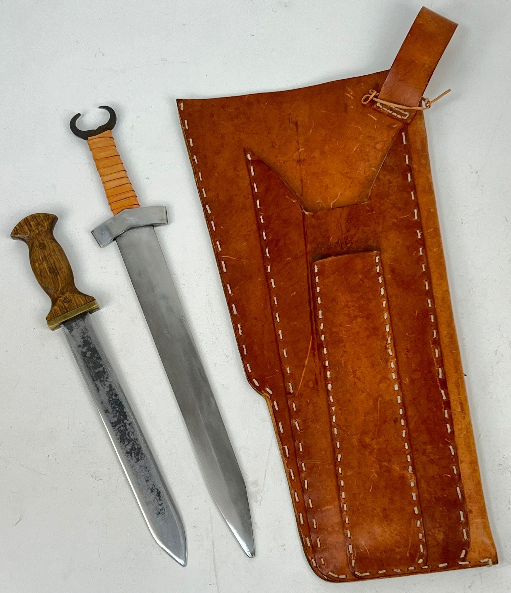 A Vintage Leather Quiver and Double Sword Holder complete with a Wood, Brass and Steel Long Knife