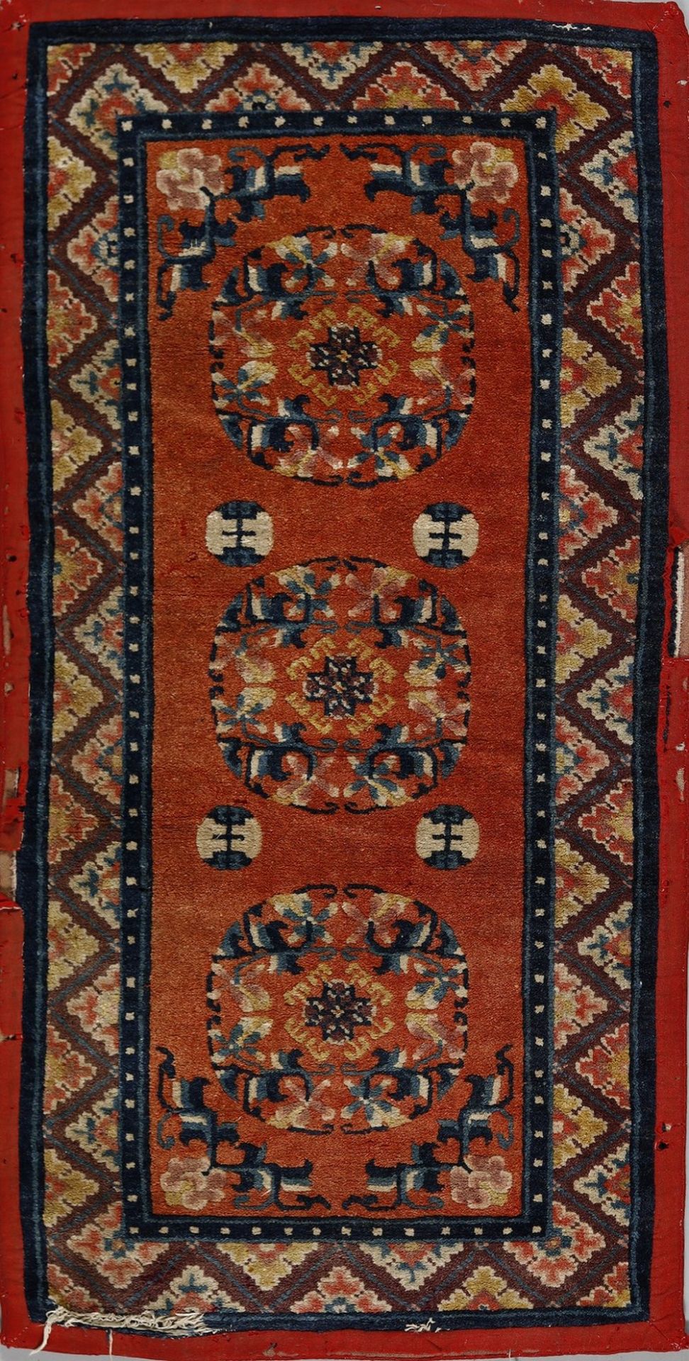 .  A Tibetan rug decorated with chevron in the border early 20th century .