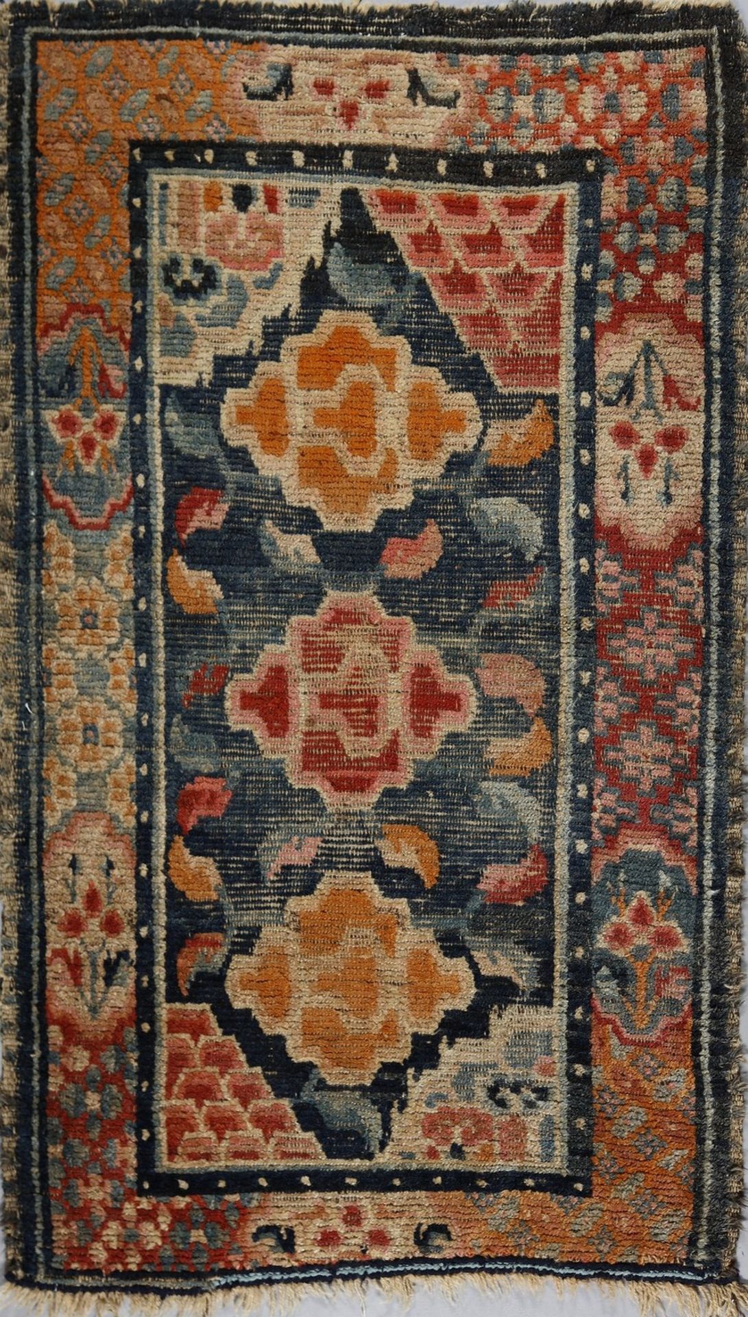 .  A Tibetan rug with peonies Tibet, early 20th century .