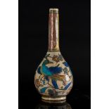 Arte Islamica A pottery bottle painted with flowers and birds Iran, late 19th century .