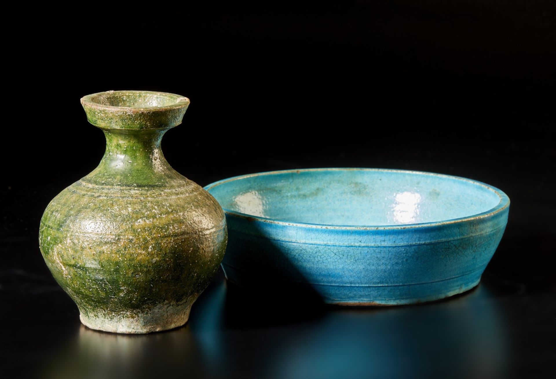 Two pottery vessels China, Ming dynasty, 15th century Including: A green glazed Han bottle vase