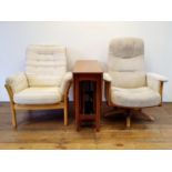 An Ercol armchair, another, a pair of armchairs, a drop leaf table, and four wall hanging display