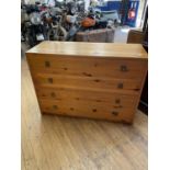 A pair of pine chests, having three drawers, 104 cm wide, a matching bedside chest, and two wine