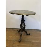 A 19th century papier mache table, inlaid with mother of pearl, decorated flowers and highlighted in