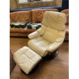 A white leather reclining easy chair, and a matching stool (2)