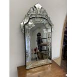 A Venetian style wall mirror, 76 x 44 cm Plate coming off in places, some rough areas to touch