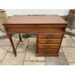 A mahogany kneehole desk, with a hinged top above four drawers, 102 cm wide