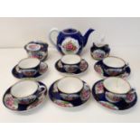 A Russian tea set, comprising teapot, sugar bowl, cream jug, six cups and saucers One cup cracked