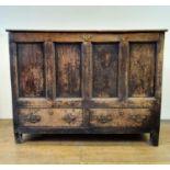 An oak mule chest, with a hinged top above two drawers, 122 cm wide Variation of colour, various