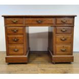 An early 20th century oak pedestal desk, 107 cm wide, and a drop leaf table, 76 cm wide (2) The