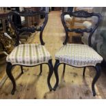 A set of four 19th century rosewood balloon back dining chairs, with carved top rails and padded