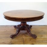 A 19th century pollard oak centre table, raised on a carved column support to four splayed legs, 121