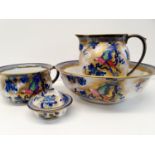 A late 19th/early 20th century jug and washbowl, decorated parrots, a pair of Staffordshire flatback