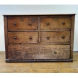 An oak chest, having four short and one long drawer, 117 cm wide Variation of colour, split and
