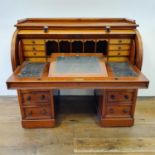 A 19th century mahogany cylinder desk, with a fitted interior, on a base with six drawers, 122 cm