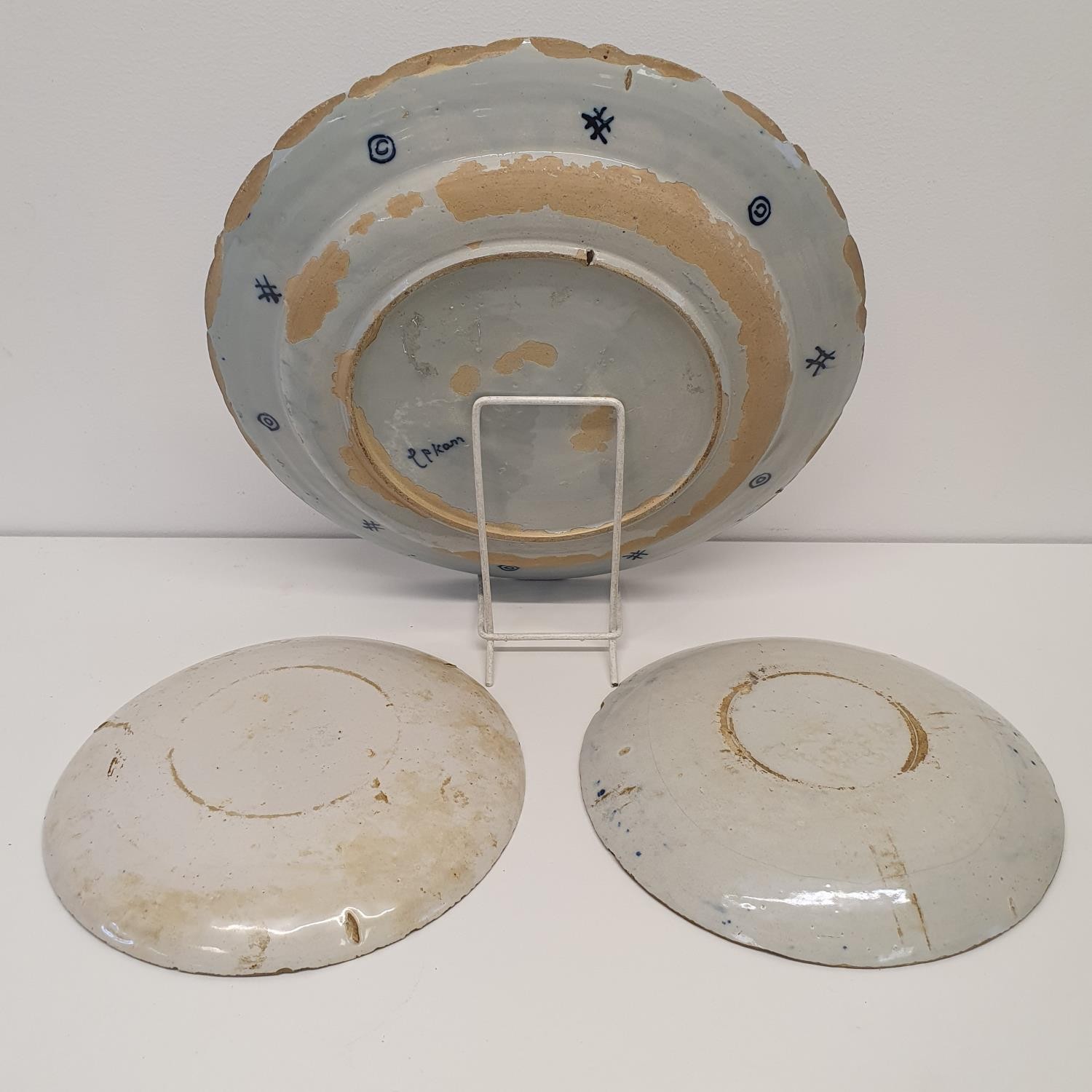 A 19th century Delft plate, 34 cm diameter, and two plates, 23 cm diameter (3) All with various - Image 2 of 3