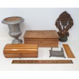 A miniature cast iron garden urn, a carved Chinese box, various printing blocks, and assorted