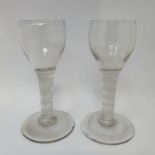 A near pair of cordial glasses, with double cotton twist stems, 12.5 cm high, one with a foot rim