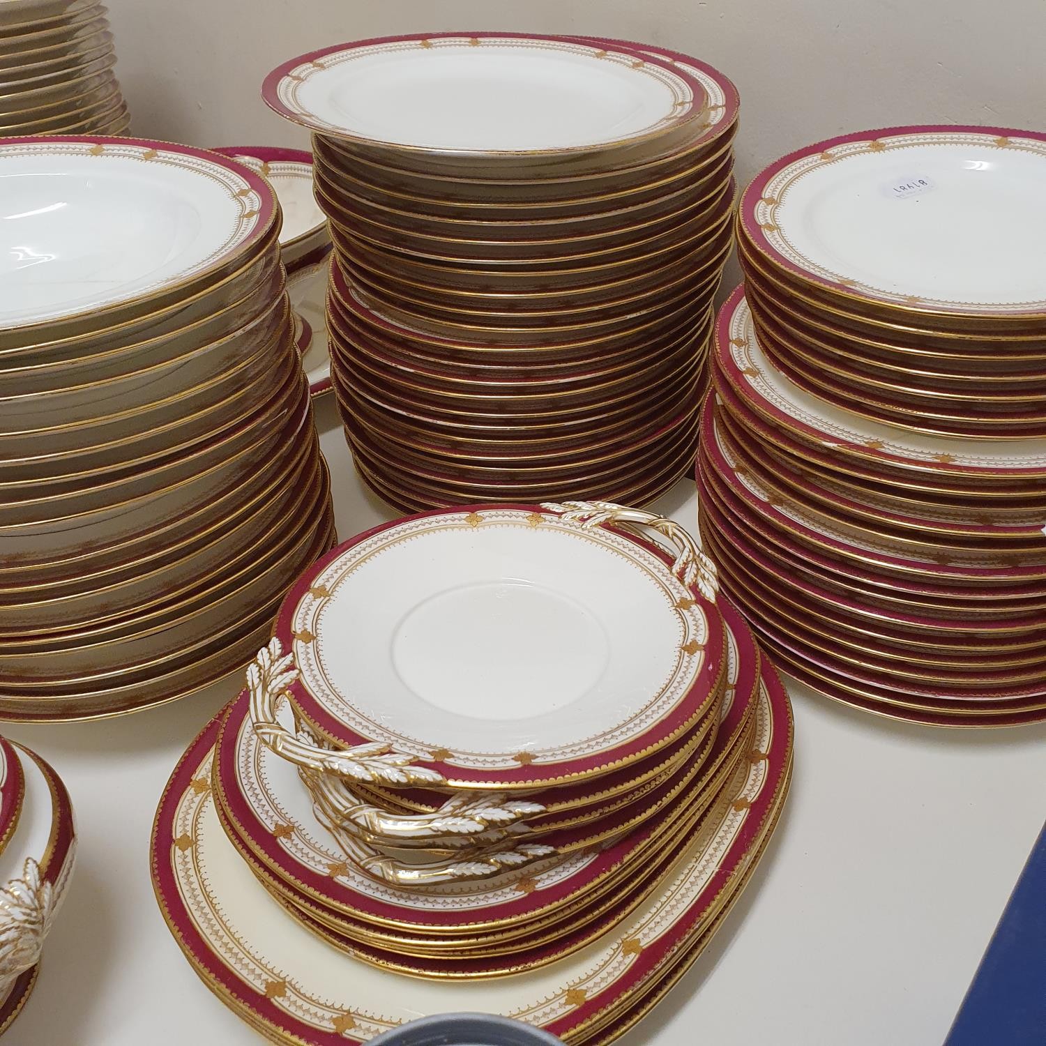 An extensive late 19th/early 20th century dinner service, decorated with a dark pink border, - Image 3 of 5