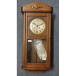 An oak wall clock, 77 cm high