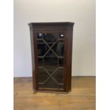 A mahogany corner cabinet, with a glazed door, 68 cm wide