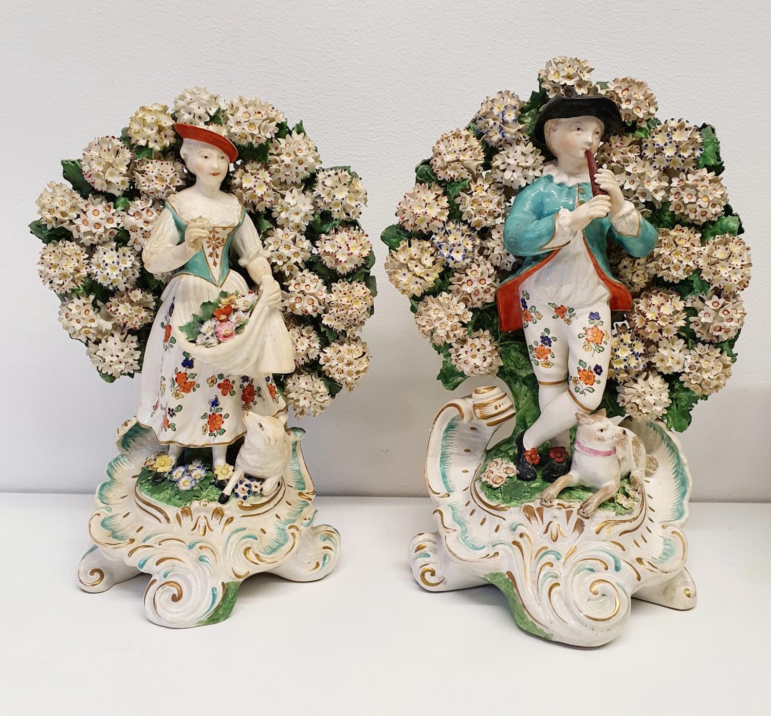 A pair of Sampson porcelain figures, with Derby red anchor marks, slight loss, 25 cm and 27 cm