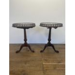 A pair of George III style mahogany tray top tables, on carved column supports, to tripod bases,