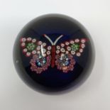 A glass paperweight, decorated a butterfly, 7.5 cm diameter A few air bubbles, no visible bruising