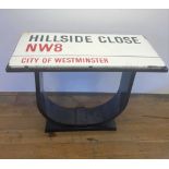 An enamel street sign, Hillside Close NW8, City of Westminster, set into the top of a table, 107