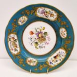 A Sevres style porcelain plate, painted fruit and foliage, within a turquoise and gilt border, No