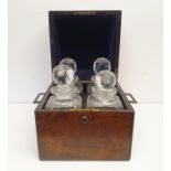 A 19th century walnut decanter box, fitted with four decanters, 25 cm wide Box split, some chips