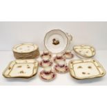 A Wedgwood cream ground dessert service, a Coalport plate, decorated landscape, and a set of six