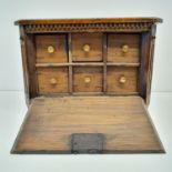 A Dutch table top collectors cabinet, the fall front to reveal six drawers, 27 cm wide,