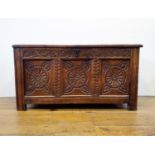 An 18th century oak coffer, with a later carved front, 120 cm wide
