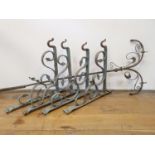A set of four wrought iron wall hooks, 60 cm wide and a part of a gas standard lamp 170 cm high (5)