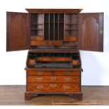 An 18th century walnut bureau bookcase, the top having two mirrored doors, to reveal a fitted