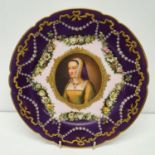 A French porcelain plate, decorate Anne de Bretagne, within a puce and pink border, decorated floral