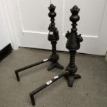 A pair of cast iron fire dogs, 54 cm high