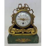 A 19th century mantel clock, the 6 cm diamete enamel dial with Arabic numerals, in a gilt metal