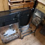 A pair of cast iron fire dogs, 42 cm high, four spark guards, a fire surround, a fire basket and a