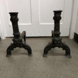 A pair of 17th century style cast iron fire dogs, 40 cm high (2)