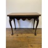 A 19th century mahogany folding card table, on carved cabriole legs to ball and claw feet, 97 cm