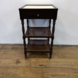 A mahogany two tier bedside table, with a marble top, 43 cm wide