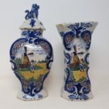 A Delft polychrome vase and cover, 25 cm high, and a similar vase, 19 cm high (2) Various losses