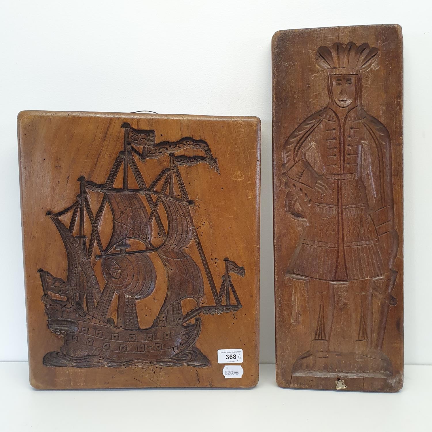 A treen cookie mould, carved figure of a man, 55 cm, and another, carved in the form of a galleon (