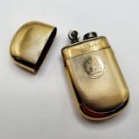 A 9ct gold mounted lighter, crested, and with engine turned decoration, 6 cm high